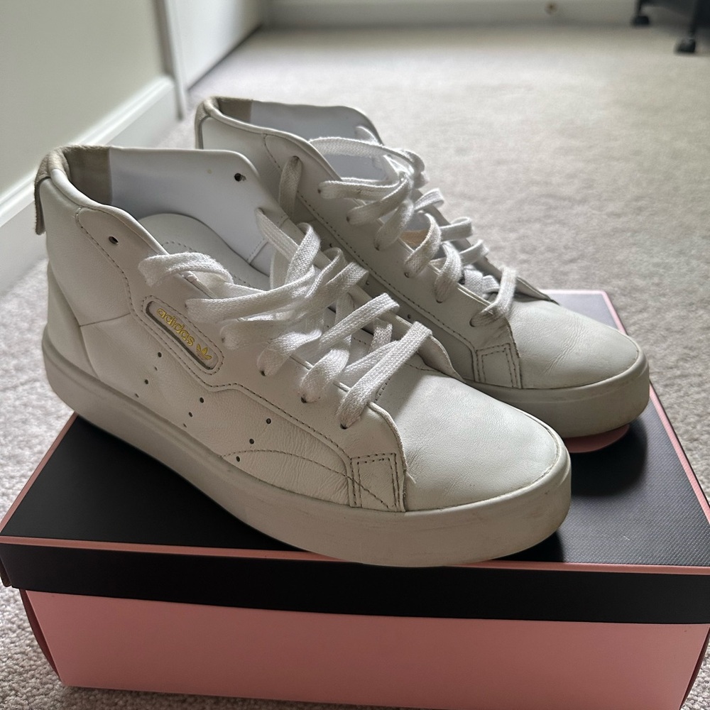 Women’s Adidas high top leather tennis shoes.